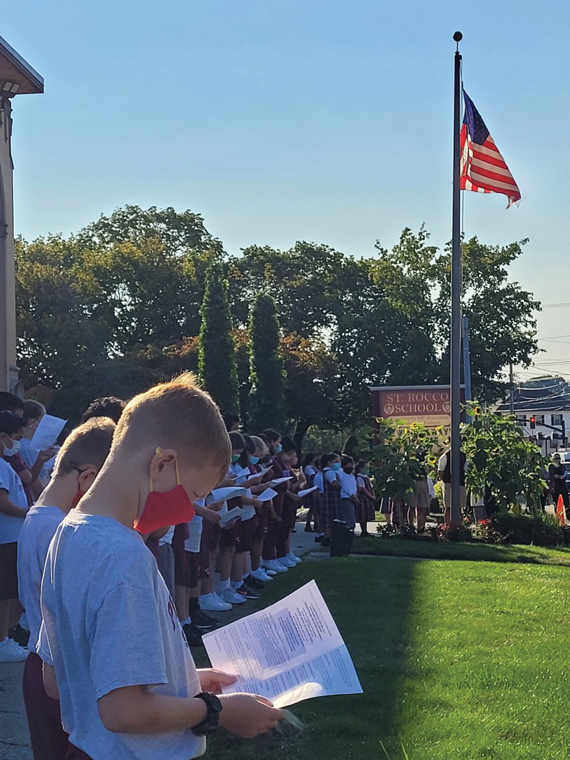 PRAYERS FOR THE LOST: St. Rocco School students read prayers and sang God Bless America in honor of the nearly 3,000 killed on 9/11 20 years ago.